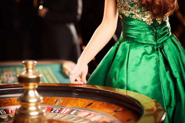 A young woman relaxing with her phone while dynamic casino elements float around her, illustrating the smooth mobile experience offered by the SPORTYBEF app.